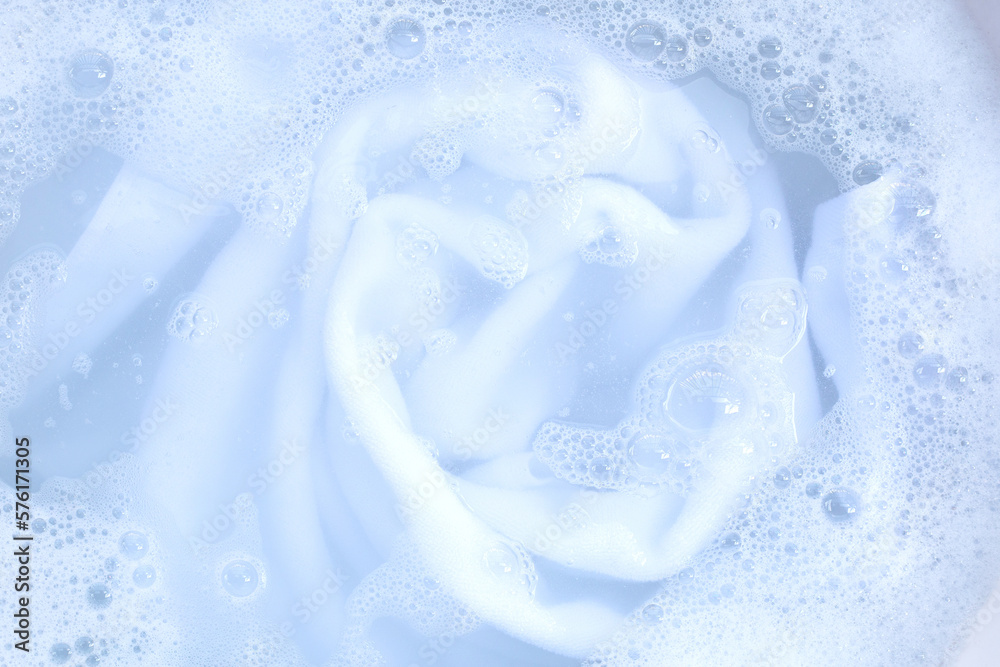 Top view of towel soak in powder detergent water dissolution. Laundry concept Top view of towel soak in powder detergent water dissolution. Laundry concept