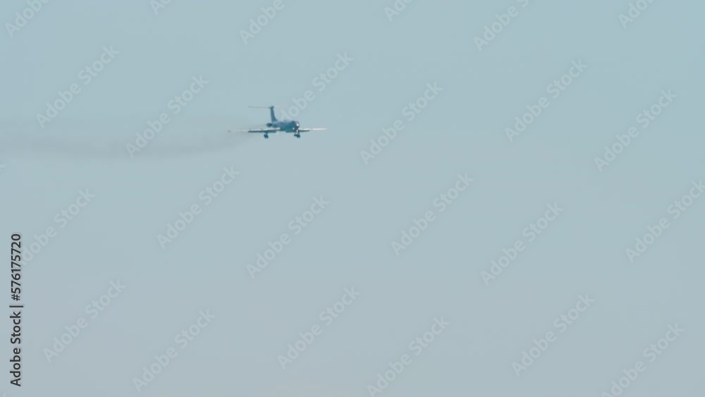 Long shot of an unrecognizable jet plane approaching for a landing. Airliner in the blue sky. Tourism and travel concept Long shot of an unrecognizable jet plane approaching for a landing. Airliner in the blue sky. Tourism and travel concept