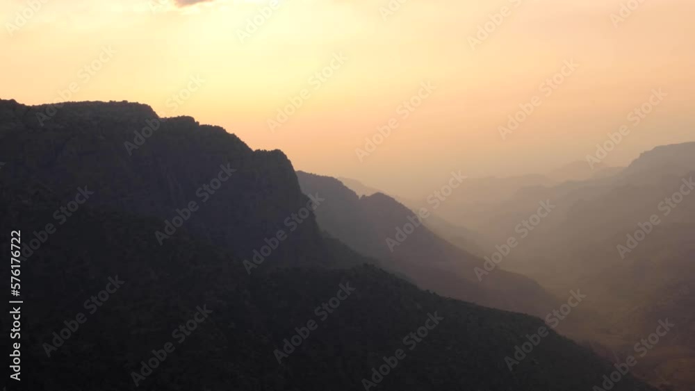 Pastel coloured hazy twilight sunset over Dana Biosphere Reserve in Rift Valley, rugged mountainous landscape view, Jordan, Middle East Pastel coloured hazy twilight sunset over Dana Biosphere Reserve in Rift Valley, rugged mountainous landscape view, Jordan, Middle East