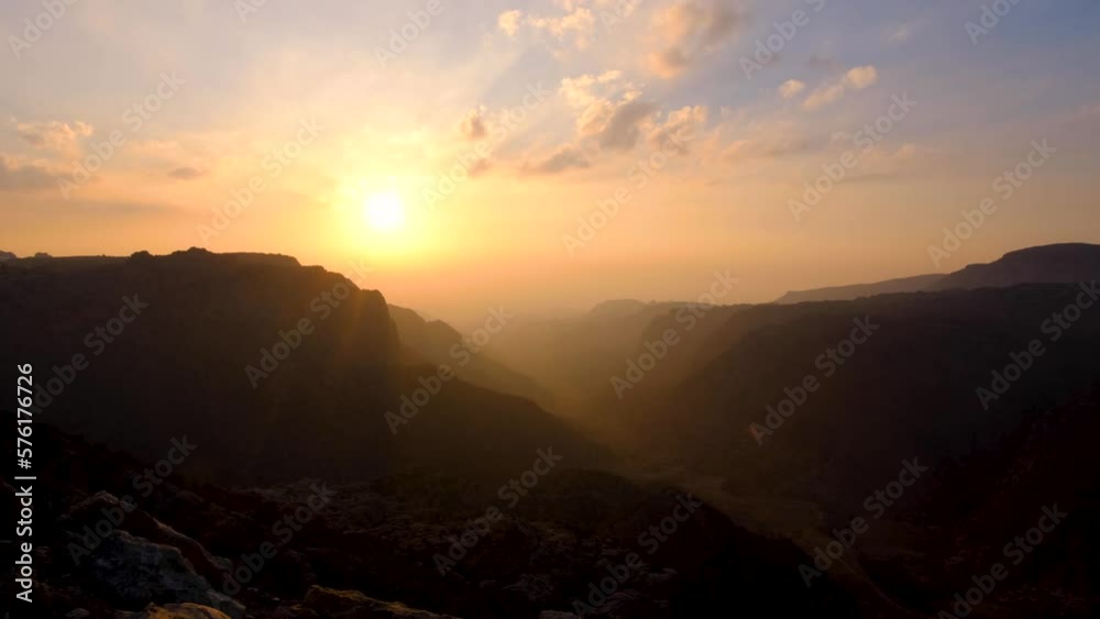 Time lapse of sunset over Dana Biosphere Reserve and Rift Valley in Jordan, epic rugged mountainous canyon view in Middle Eastern landscape