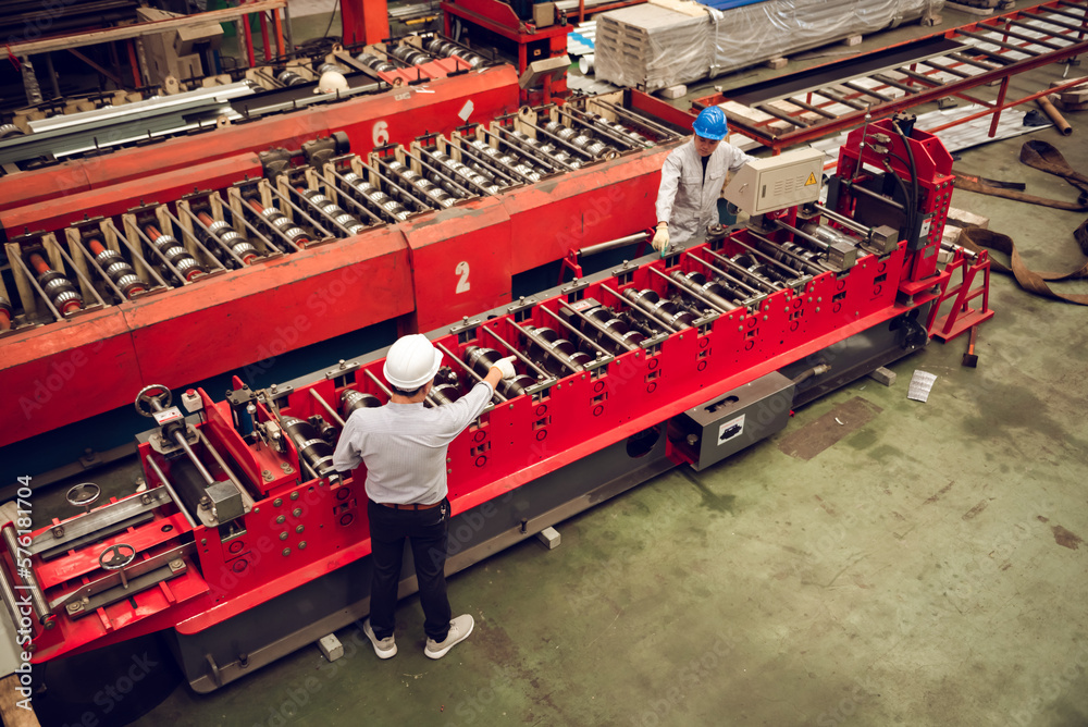 Factory worker male wearing protective helmets for work in workplace. Heavy metal industry manufacturing factory. Factory worker male wearing protective helmets for work in workplace. Heavy metal industry manufacturing factory.