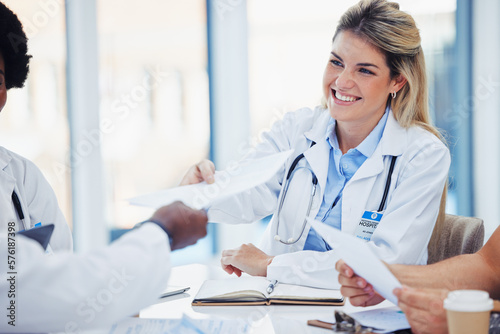 Healthcare, doctors and woman with smile, documents and meeting for planning, admin and conversation. Medical professional, female employee and coworkers with forms, feedback and reports in hospital photo
