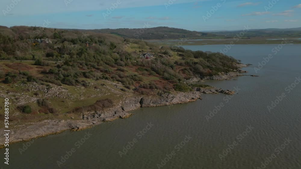 Wide view of rugged English coastline with hills revealed in distance at Silverdale UK Wide view of rugged English coastline with hills revealed in distance at Silverdale UK