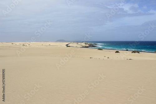 People playing in the Sahara Desert. Jumps and walks on the dunes of the Corralejo natural park.