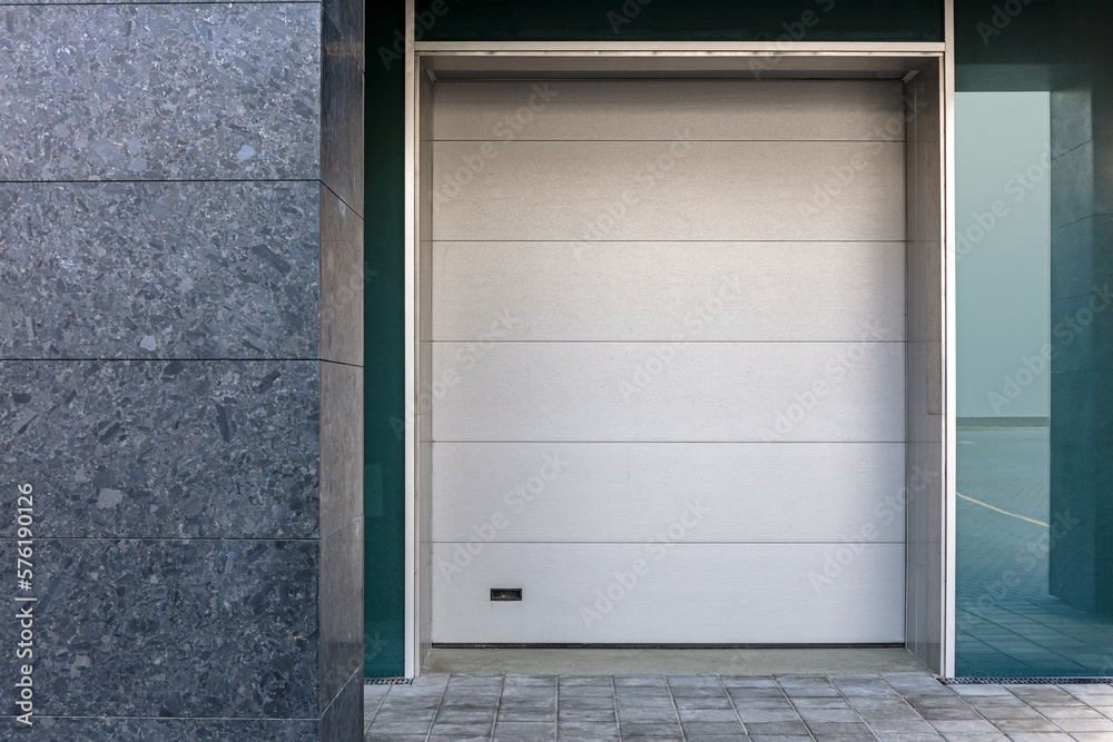 Fototapeta premium closed roller shutter door on building facade. urban background. architecture.