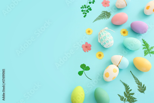 Top view of easter colorful eggs over pastel blue background