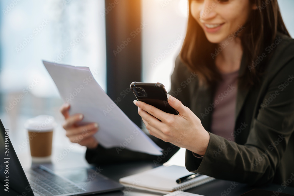 Businesswoman hand using smart phone laptop and tablet with social network diagram on desk as concept in morning light. Businesswoman hand using smart phone laptop and tablet with social network diagram on desk as concept in morning light.