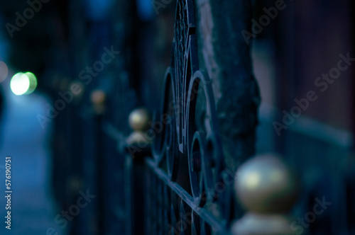 Wrought iron gate at night. Shallow dept of field