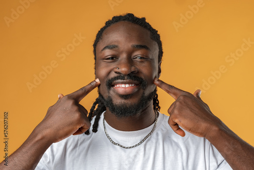 Head shot portrait of happy African man smiling.