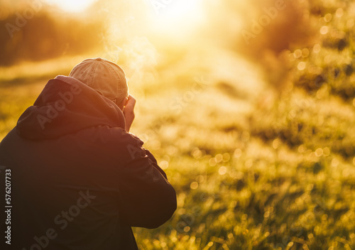Man taking photo landscape with a big professional camera