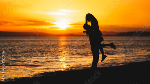 Couple on a beach, sunset, ocean