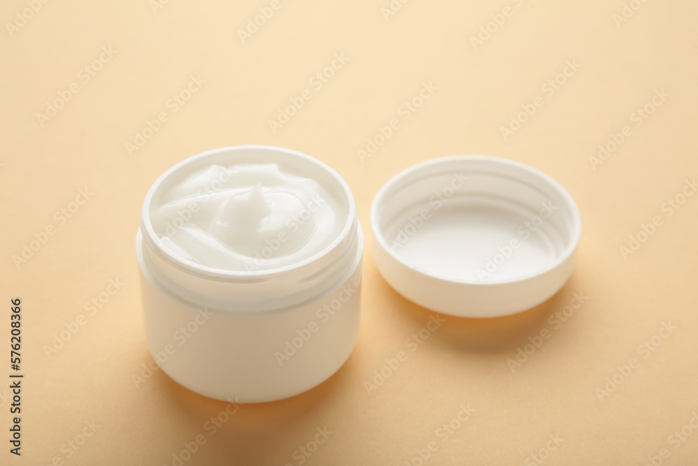 Face cream moisturizer in a jar on beige background. Luxury skincare cosmetics and anti-aging product for healthy skin and beauty routine Face cream moisturizer in a jar on beige background. Luxury skincare cosmetics and anti-aging product for healthy skin and beauty routine