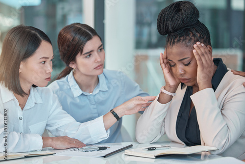 Headache, stress and support with a business black woman suffering from burnout while colleagues console her. Anxiety, mental health and depression with a female employee group comforting a coworker