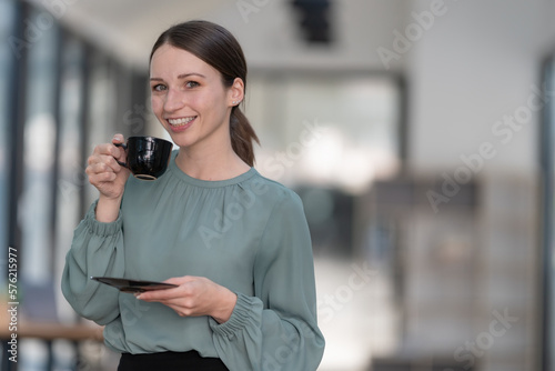 Beautiful woman enjoying a cup of coffee. © Songsak C