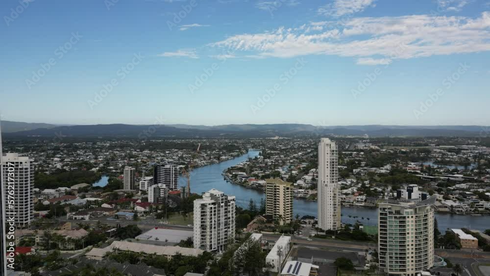 Drone sky view of crowded houses and apartment along a river and beaches where people live, learn, play and work Drone sky view of crowded houses and apartment along a river and beaches where people live, learn, play and work