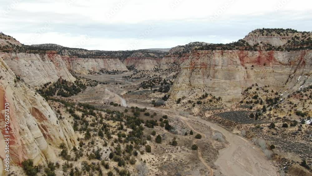 Aerial above red desert landscape with off road trails, river and red buttes outside Zion in southern Utah Aerial above red desert landscape with off road trails, river and red buttes outside Zion in southern Utah