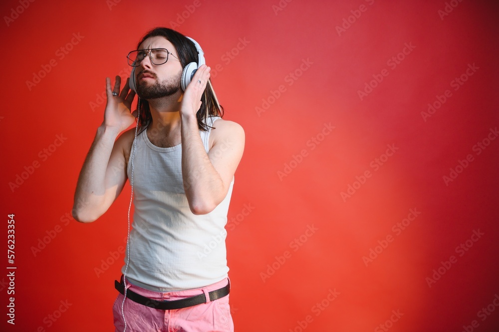Obraz premium Young, handsome gay man on a colored background in the studio. LGBT concept.