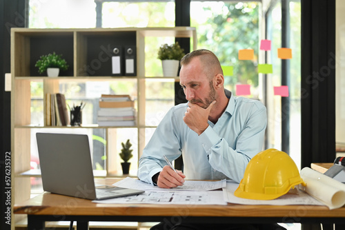 Focused engineer man watching online webinar training or having virtual meeting video conference on laptop