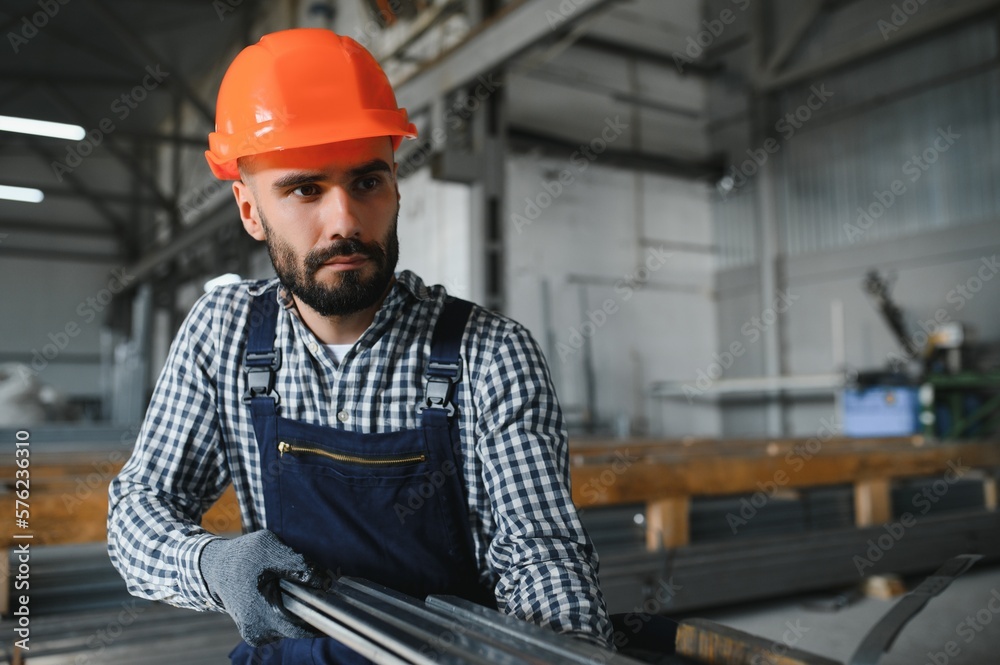 Factory worker measures the metal profile Factory worker measures the metal profile