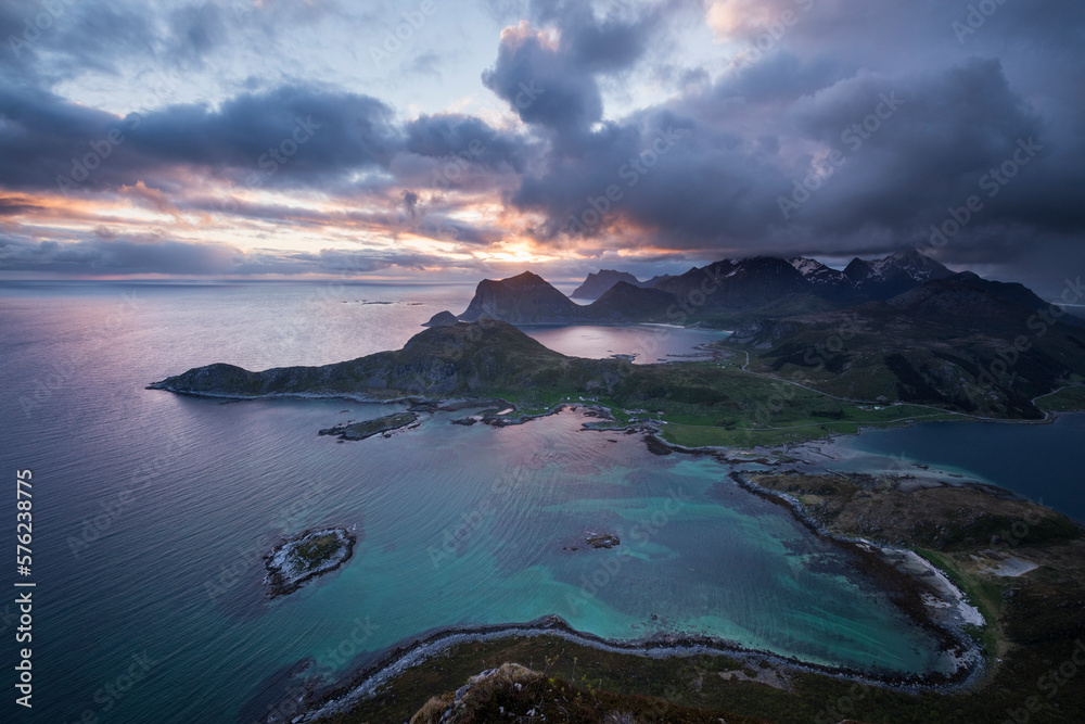 MIdnight sun view over coastal landscape from summit of Offersøykammen mountain peak, Vestvågøy, Lofoten Islands, Norway MIdnight sun view over coastal landscape from summit of Offersøykammen mountain peak, Vestvågøy, Lofoten Islands, Norway