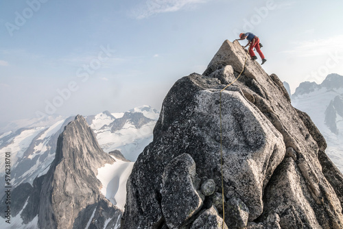 Mountain climber climbing up Bugaboo Spire, Bugaboo Mountains, British Columbia, Canada photo