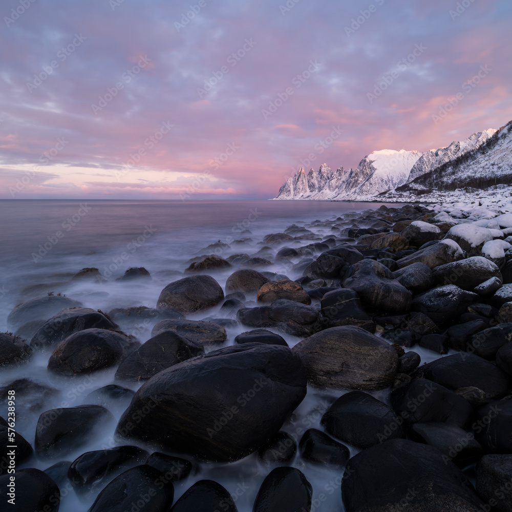 View from rocky coastline of Steinfjord toward Okshornan, Senja, Norway