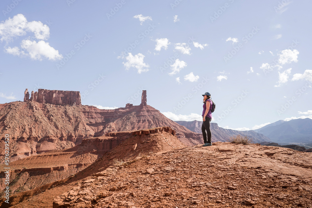 Female trail runner near Castletown Tower in Castle Valley outside Moab, Utah Female trail runner near Castletown Tower in Castle Valley outside Moab, Utah