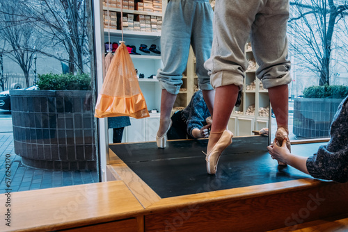 Girl being fitted for ballet shoes
