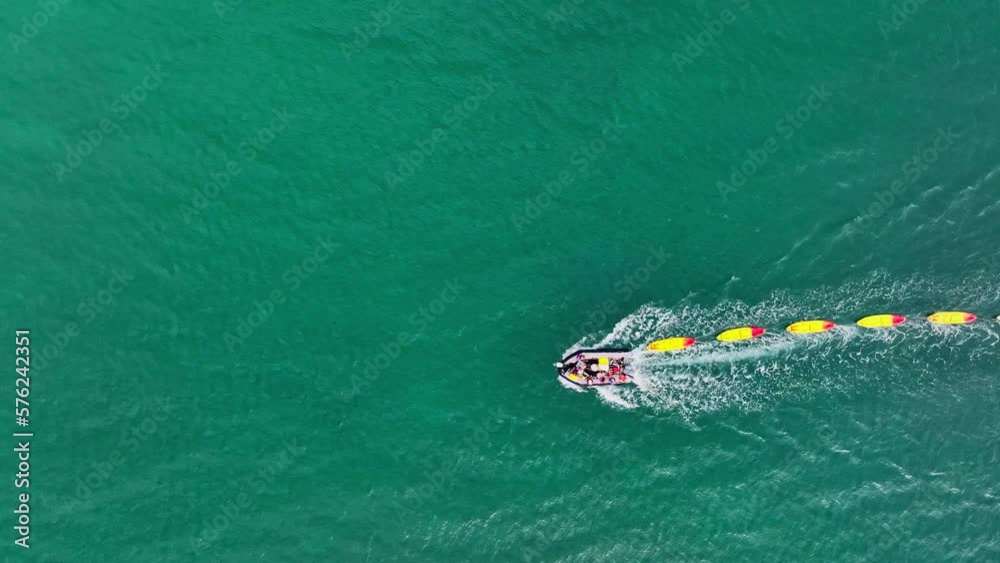Top down aerial shot of inflatable powered boat carrying kayak boats