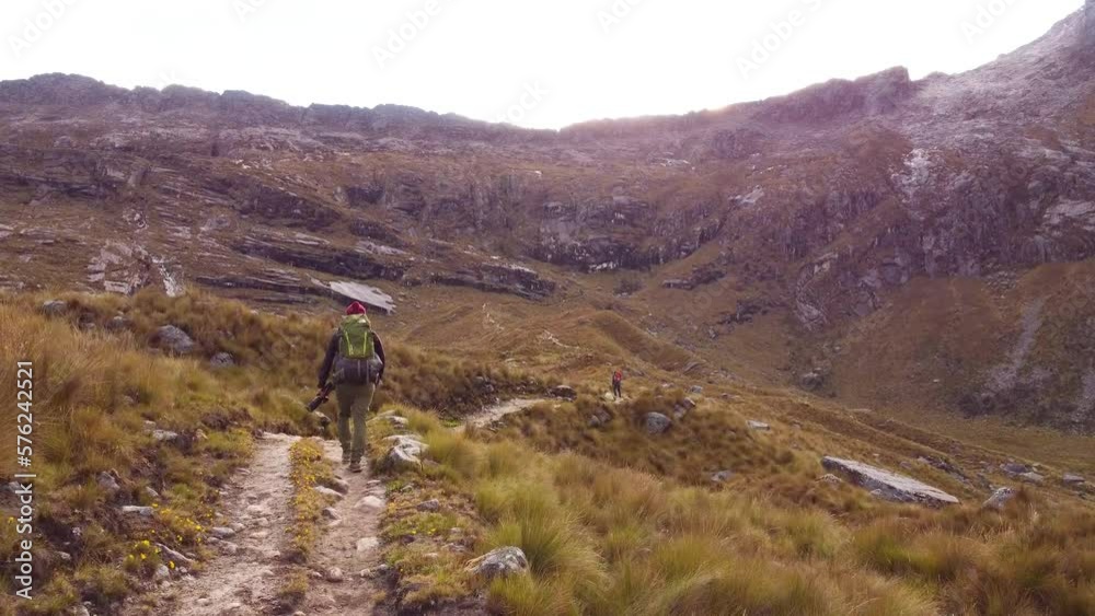 Tracking Shot Of Group Of Campers Hiking In Green Mountains Landscape, Peru Tracking Shot Of Group Of Campers Hiking In Green Mountains Landscape, Peru