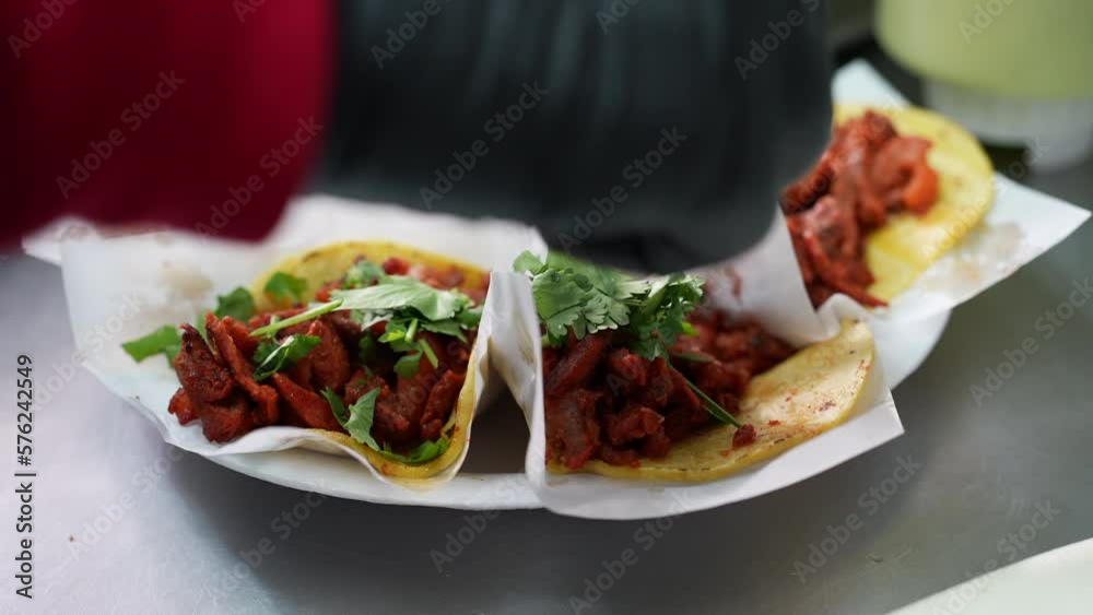 Sprinkling chopped cilantro on a platter of street tacos - food truck series Sprinkling chopped cilantro on a platter of street tacos - food truck series