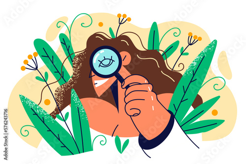 Woman with magnifying glass spying and hiding in bush working as detective and doing investigation