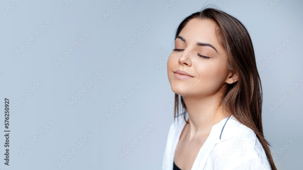 Smiling girl enjoying beauty treatment and posing with closed eyes Smiling girl enjoying beauty treatment and posing with closed eyes