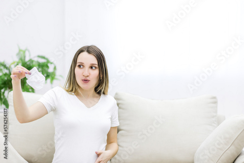 Beautiful pregnant woman in white t-shirt holding small socks. Free Download Beautiful pregnant woman in white t-shirt holding small socks. - GFXLoad