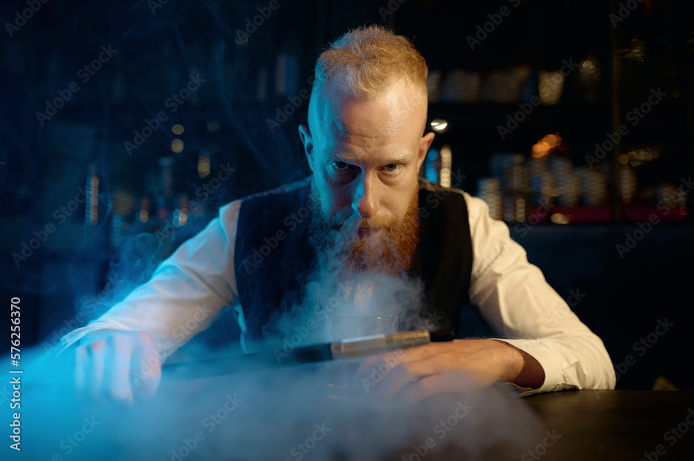 Portrait of stylish bearded man exhales smoke while smoking hookah Portrait of stylish bearded man exhales smoke while smoking hookah