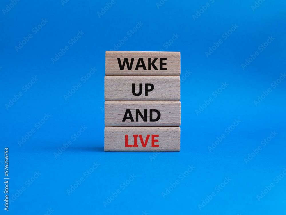 Wake up and live symbol. Wooden blocks with words Wake up and live. Beautiful blue background. Business and Wake up and live concept. Copy space. Wake up and live symbol. Wooden blocks with words Wake up and live. Beautiful blue background. Business and Wake up and live concept. Copy space.