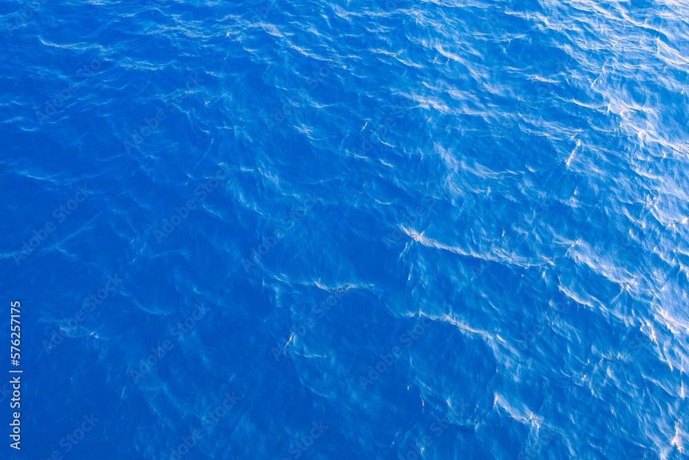 Very nice sea water background or backdrop with selective focus. Small waves of natural water surface texture.