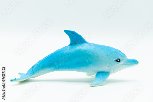 Miniature and game for children of a white and light blue dolphin on a white background.