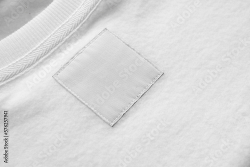 Leinwand Poster Blank white laundry care clothes label on fabric texture background