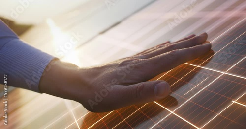 Close Up on Hand Of Professional Maintenance Engineer Touching Industrial Solar Panel Generating Electricity. VFX Graphics Animation Visualizing Energy Being Generated. Green Energy Concept. photo
