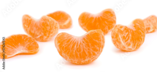 Peeled fresh mandarin, segments, white background, macro