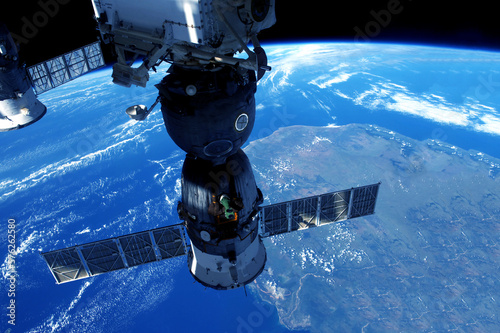 Fototapeta Naklejka Na Ścianę i Meble -  Spacecraft docked at ISS. Elements of this image were furnished by NASA