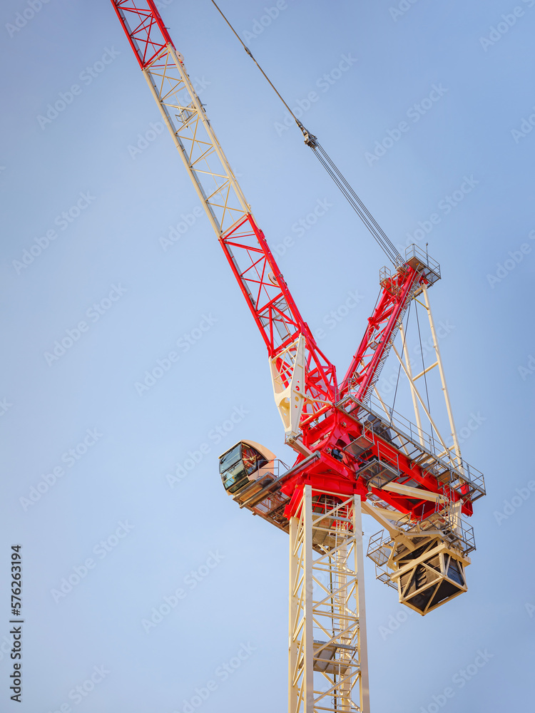 Silhouette of construction crane against cloudy sky. Housing construction, apartment block in city, restoration work in the city . Summer Travel to capital of Austria Vienna. Silhouette of construction crane against cloudy sky. Housing construction, apartment block in city, restoration work in the city . Summer Travel to capital of Austria Vienna.