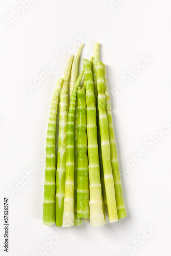 Peeled green bamboo shoots isolated on white background.
