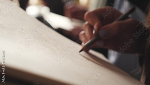 The artist draws a sketch on a piece of paper