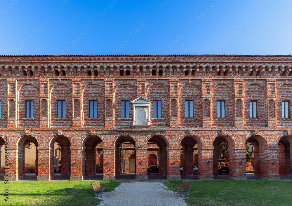 Beautiful red brick facade with columns and arches of Galleria degli Antichi in Sabbioneta city. Lombardy, Italy