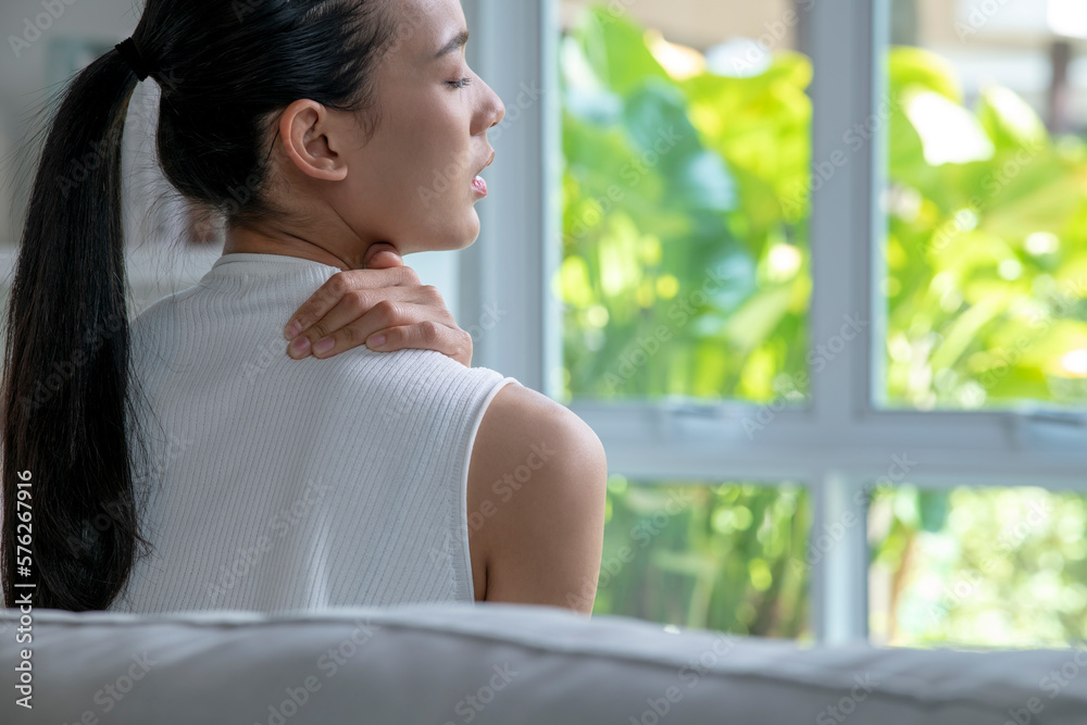 Asian woman has shoulder pain. Female holding painful shoulder with another hand. People with body-muscles problem, Healthcare And Medicine. Asian woman has shoulder pain. Female holding painful shoulder with another hand. People with body-muscles problem, Healthcare And Medicine.