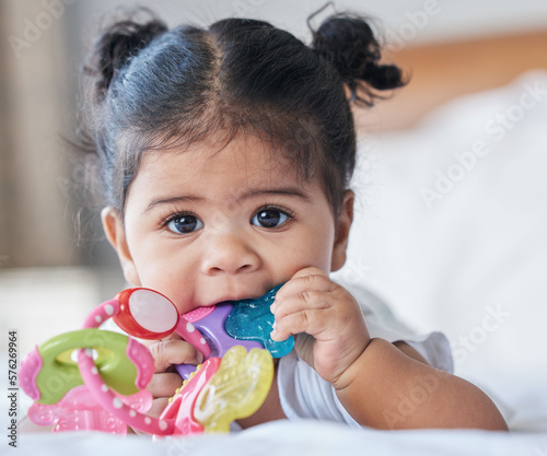 Obraz na plátne Portrait, baby girl and biting toys in bedroom, house and home for development, growth and teething progress