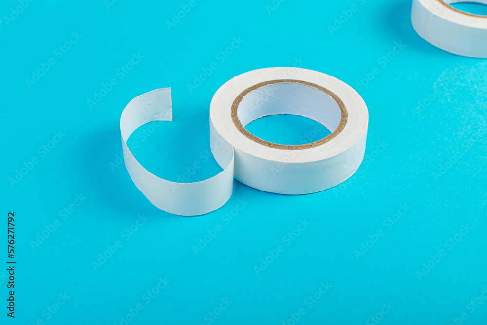 White Electrical Tape, Plastic Duct Tape Rolls, Colored Adhesive Tapes on Blue Background