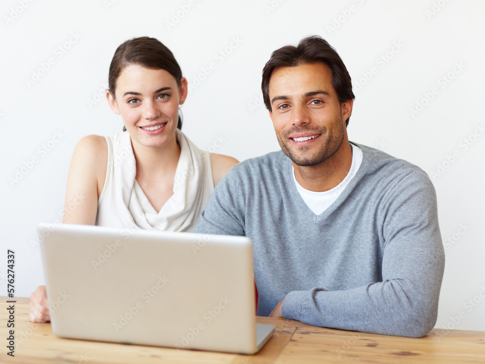 Perfect working companions. Portrait of a handsome man and a beautiful young woman working together on a laptop. Perfect working companions. Portrait of a handsome man and a beautiful young woman working together on a laptop.